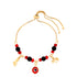 The Red and Black Evil Eye, Figa Hand and Elephant Lucky Charm Bracelet is crafted from gold-filled material. It features an adjustable chain adorned with red and black beads, highlighting a central Evil Eye charm along with two additional charms shaped like an elephant and a hand.